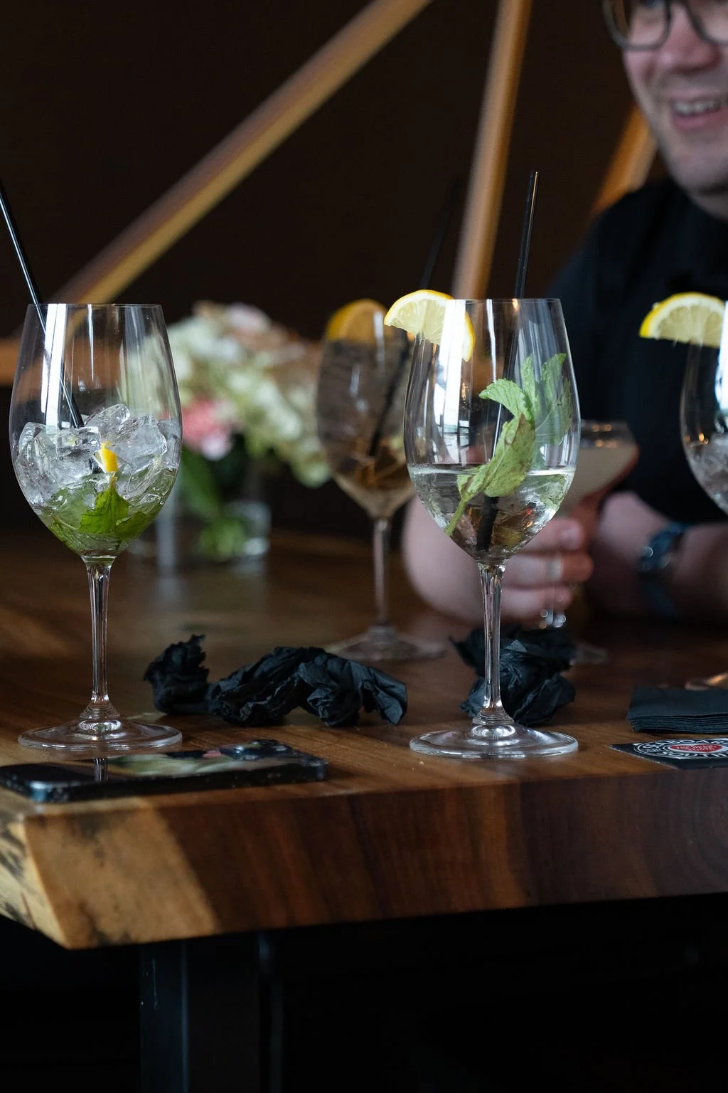 Cocktail glassware and florals styled for an engagement party