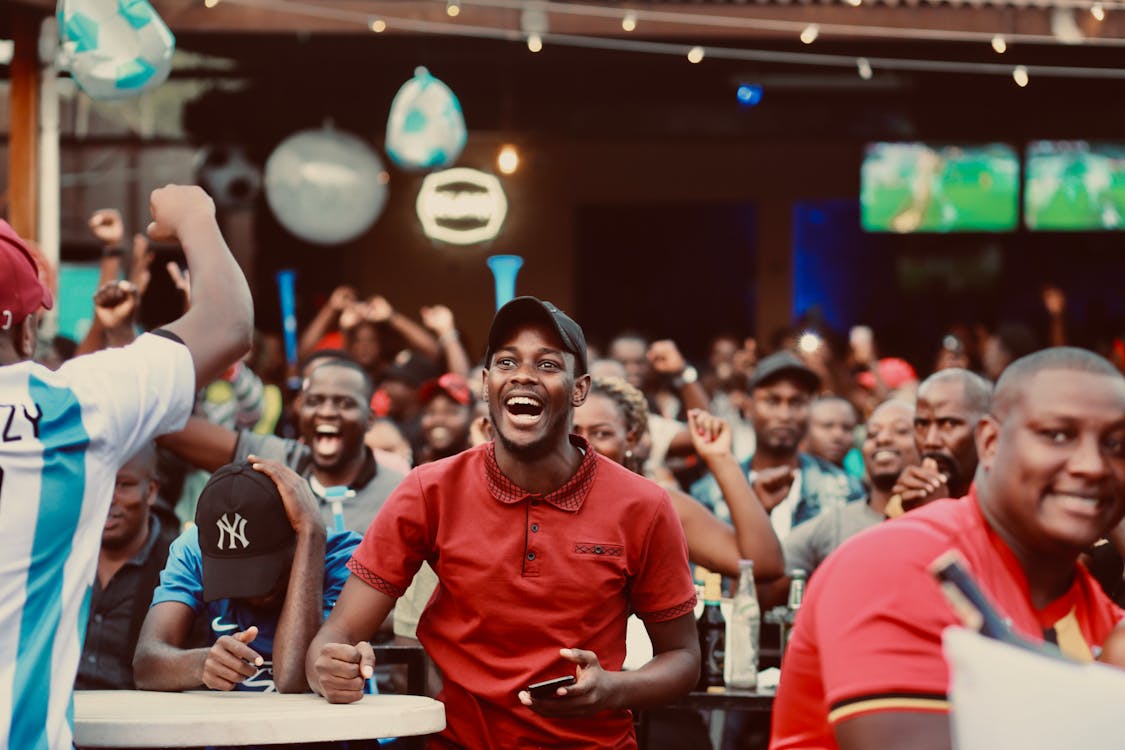 Fans watching soccer on screens at a sports bar